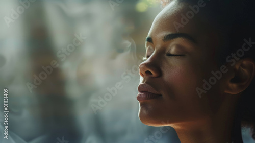 A woman is sitting with her eyes closed, practicing breathwork and meditation