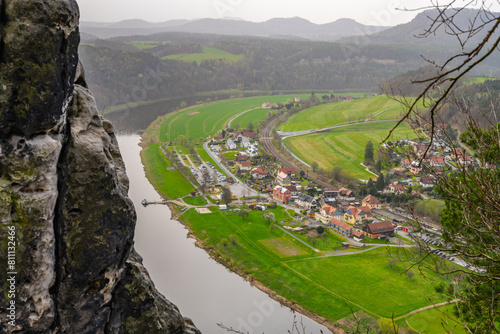Overlooking the gentle curve of the Elbe River, surrounded by the lush greenery of Saxon Switzerland National Park. Germany