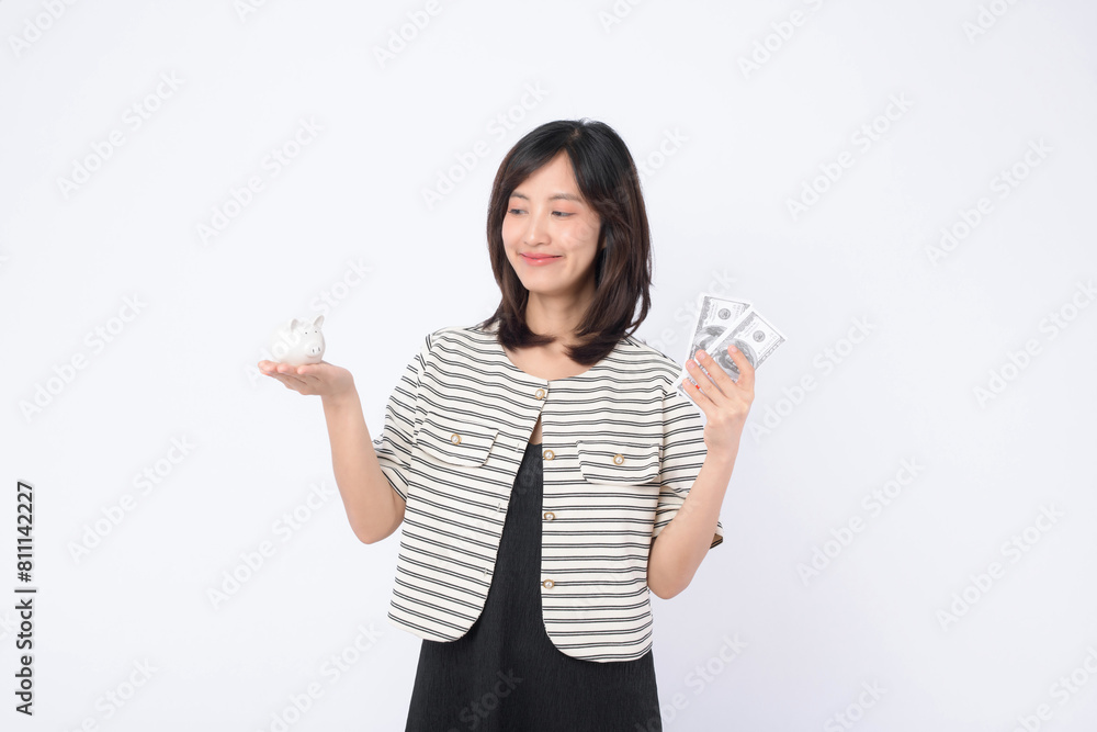 young beautiful business asian woman with a lot of cash money and piggy bank isolated on white background. Wealth money saving, finance investment concept. young beautiful business asian woman with a lot of cash money and piggy bank isolated on white background. Wealth money saving, finance investment concept.