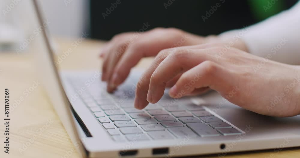 Close camera view of person using portative laptop. Hands typing information on keyboard. Working on technology device. Pressing keys to enter data. Concept of online communication. Digital gadget. Close camera view of person using portative laptop. Hands typing information on keyboard. Working on technology device. Pressing keys to enter data. Concept of online communication. Digital gadget.