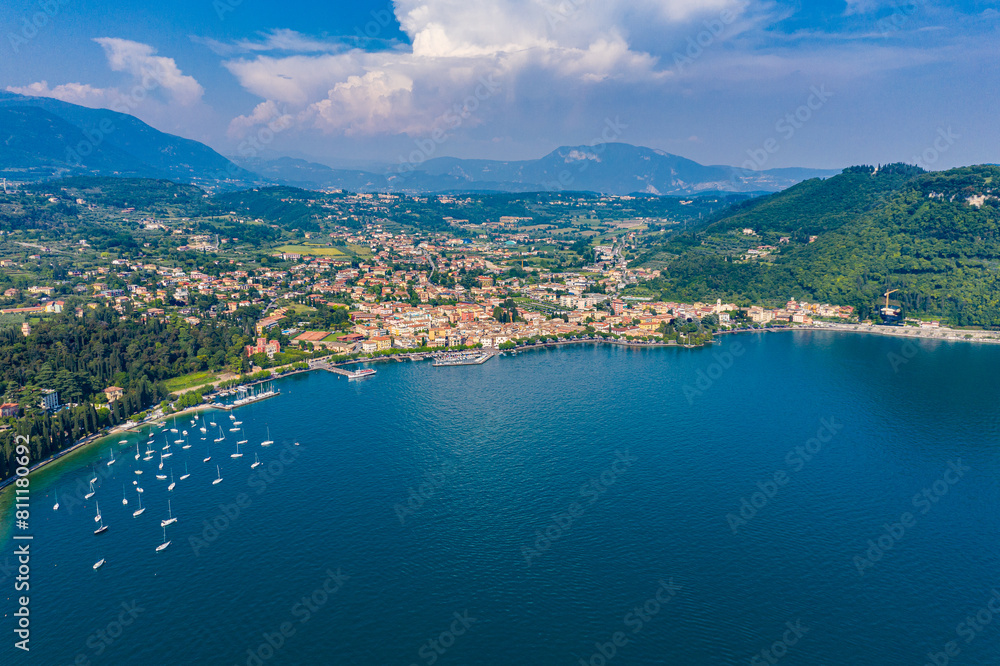 Obraz premium Aerial View of Garda Town on Lake Garda, Italy, Scenic Summer Landscape with Sailing Boats and Lush Hills
