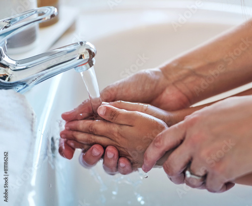 Mother  kid and hands for washing in bathroom for hygiene  bacteria and learning to remove germs or dirt. Person  family and water for cleaning in home  teaching and skincare for child development
