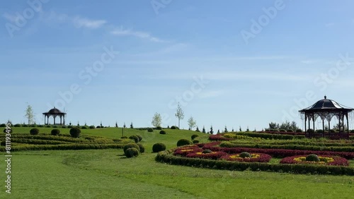 Beautiful landscaping in the park with lawns, ornamental shrubs, topiary balls. photo