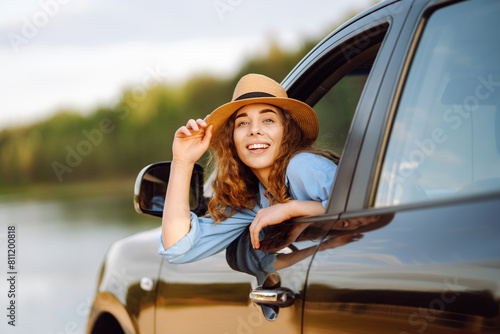 Woman relaxing out of window in a car - Freedom car travel concept. Road trip.