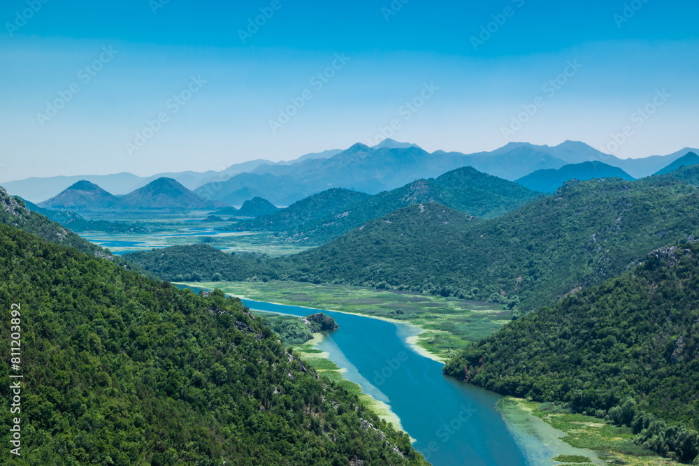 Pavlova Strana View Point. Beautiful summer landscape of green mountains, blue sky and Crnojevica river that flows into Skadar Lake. Montenegro. Pavlova Strana View Point. Beautiful summer landscape of green mountains, blue sky and Crnojevica river that flows into Skadar Lake. Montenegro.