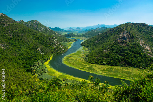 Pavlova Strana View Point. Beautiful summer landscape of green mountains, blue sky and Crnojevica river that flows into Skadar Lake. Montenegro.