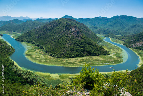 Pavlova Strana View Point. Beautiful summer landscape of green mountains, blue sky and Crnojevica river that flows into Skadar Lake. Montenegro. photo