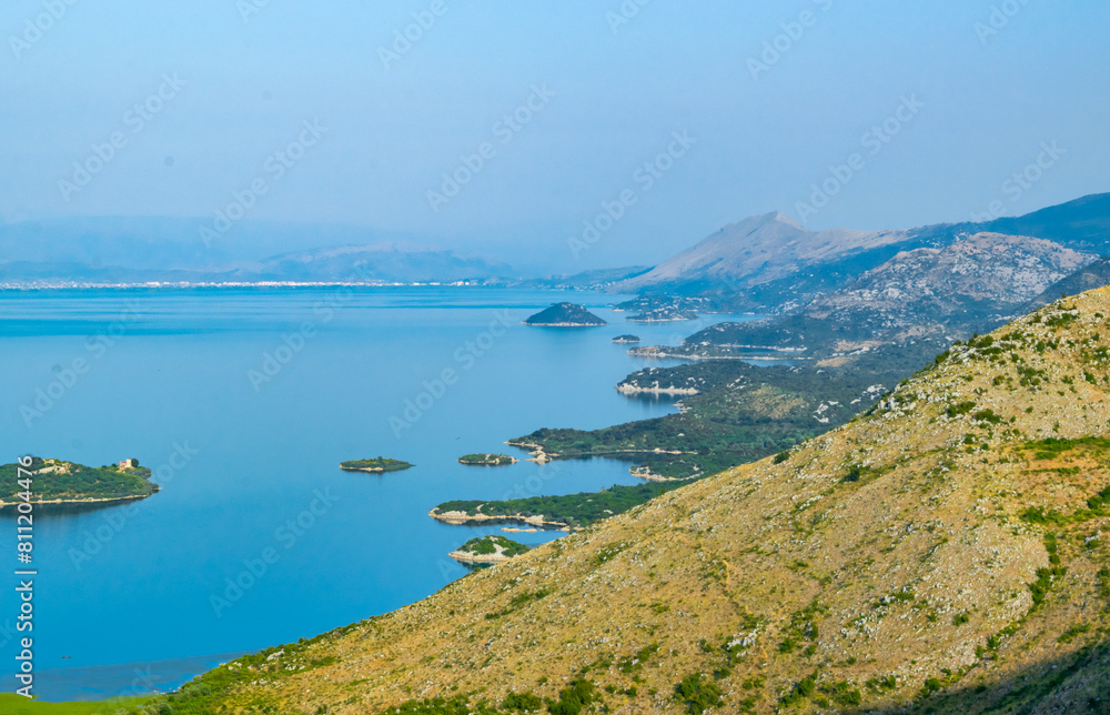 Viewpoint Donji Muriсi. Beautiful summer landscape of small green islands and blue waters of Lake Skadar near the border with Albania. Montenegro. Viewpoint Donji Muriсi. Beautiful summer landscape of small green islands and blue waters of Lake Skadar near the border with Albania. Montenegro.