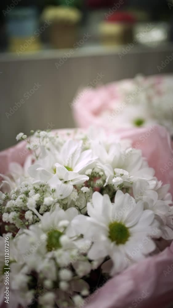 Florist Crafting Bouquet. Florist's Bouquet Design. Florist at Work. Florist's Creative Process. Florist makes bouquet in flower shop. Florist making bouquet of flowers in flower shop Vertical Florist Crafting Bouquet. Florist's Bouquet Design. Florist at Work. Florist's Creative Process. Florist makes bouquet in flower shop. Florist making bouquet of flowers in flower shop Vertical