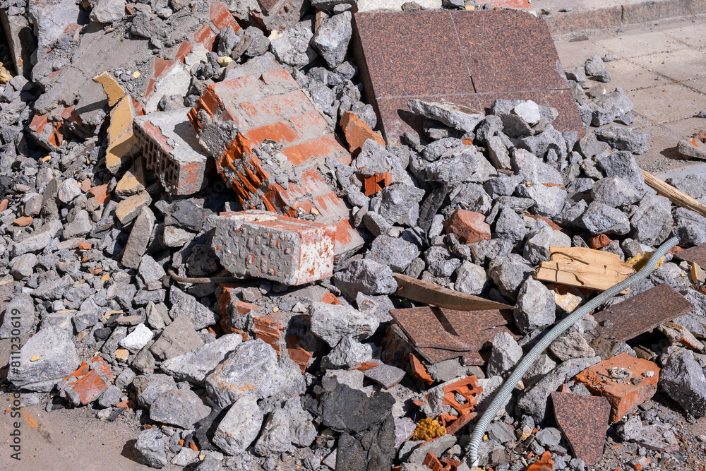 broken bricks, pieces of concrete and granite tiles on the ground after demolition of a building broken bricks, pieces of concrete and granite tiles on the ground after demolition of a building