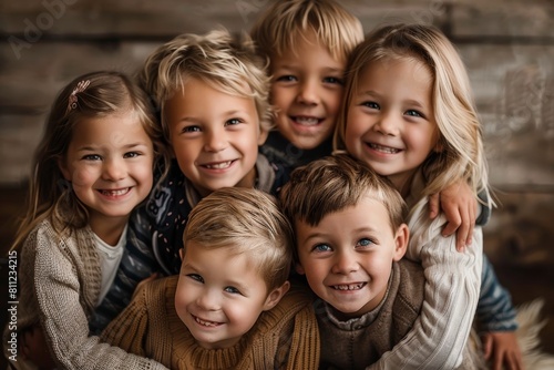 Siblings standing together, smiling, and posing for a family portrait, A group of siblings posing for a family portrait with big smiles