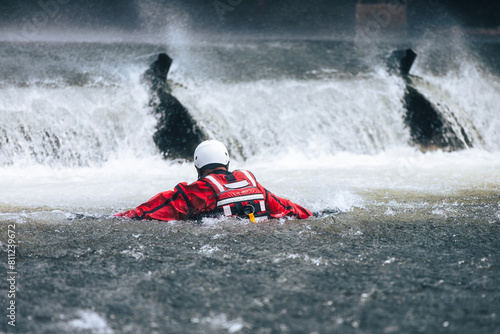 Firefighter in water under dangerous wier during drowning rescue training..
