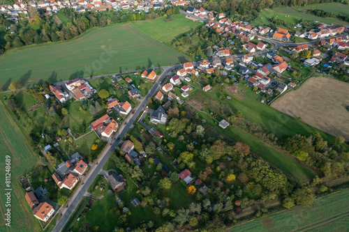 Aer ial view of a German village surrounded by meadows, farmland and forest. Thuringia, Germany. photo