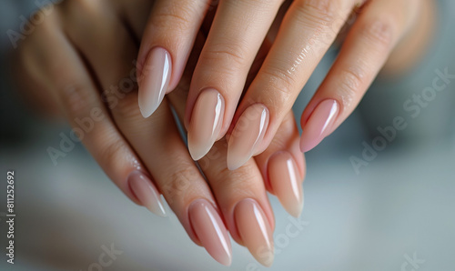 Close-up of a woman s hands with an elegant manicure in neutral tones that emphasize natural beauty and style.