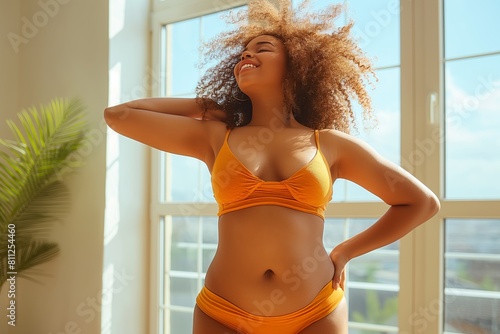 Woman in bikini posing with hands on hips photo