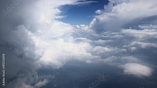 Aerial view of majestic cloudscape from an airplane window with sunlight piercing through photo