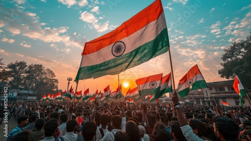 Vibrant Celebration of Patriotism: Group of People Waving Indian Flags at Sunset photo