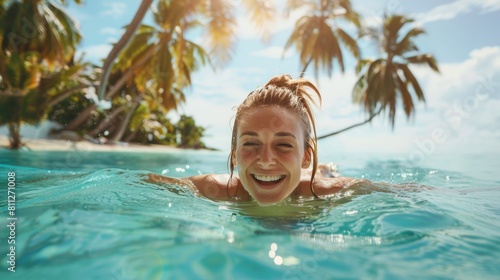 Smiling female in tropical sea with palm tree in vacation.