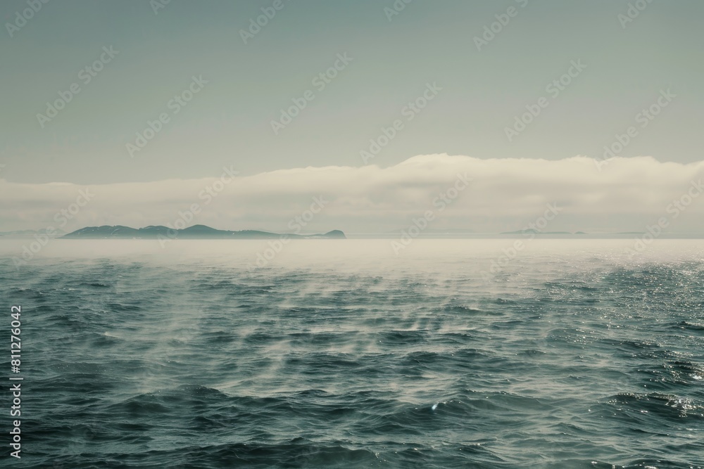 A vast body of water with a small island barely visible in the distance on a misty morning, A misty morning on the open ocean, with fog enveloping distant islands on the horizon