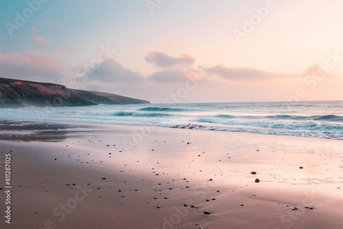 Waves gently rolling onto a sandy beach with a pastel sky in the background at sunset, A peaceful beach at sunset, with pastel skies and gentle waves crashing