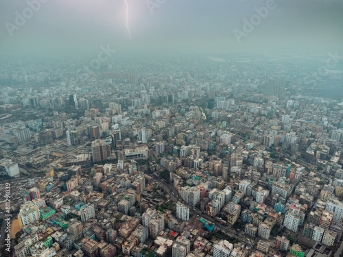 aerial view of high, congested buildings of Dhaka city with no trees and greenery visible. Thunder storm at far skyline	