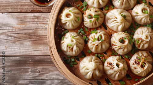 Traditional mongolian buuz: authentic steamed dumplings served in a bamboo steamer with chives and chili flakes garnish photo