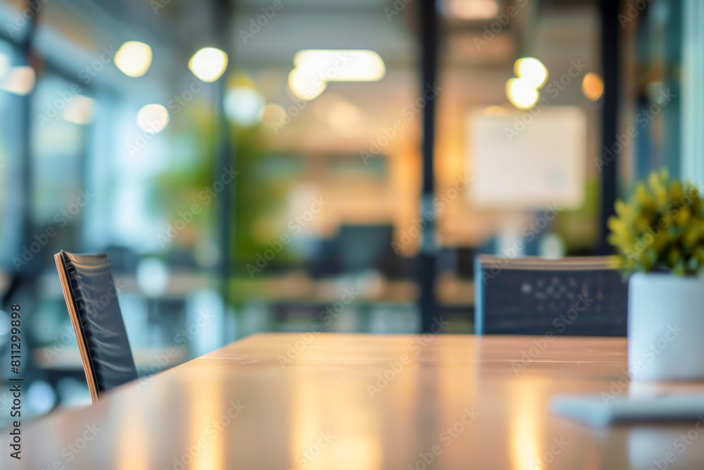 Blurred empty open space office interior background for design. Modern conference room table with comfortable chairs in foreground and blurred view of open office space beyond. Template, copy space Blurred empty open space office interior background for design. Modern conference room table with comfortable chairs in foreground and blurred view of open office space beyond. Template, copy space