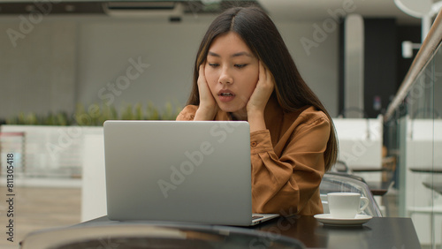 Stressed tired Asian woman female office worker businesswoman chinese korean japanese girl freelance working online with laptop computer in cafe stress business job failure project mistake on website