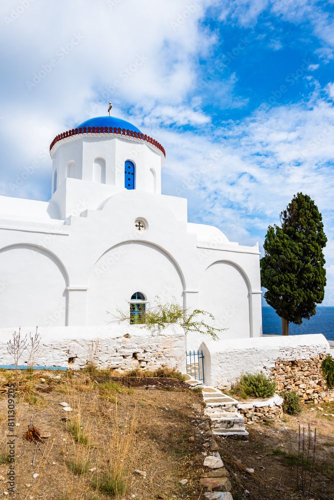 Fototapeta premium Traditional style white church Panagia Poulati with blue dome on sea coast near Kastro village, Sifnos island, Greece