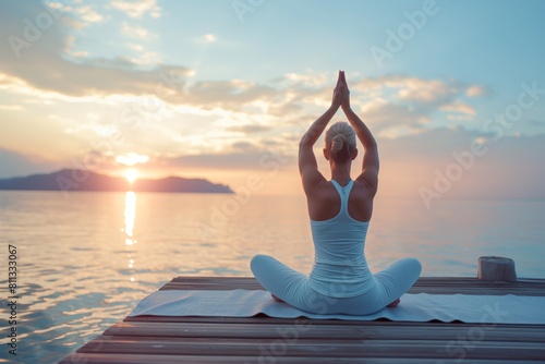 Woman doing yoga on pier at sea, sunrise in background. white , meditation concept