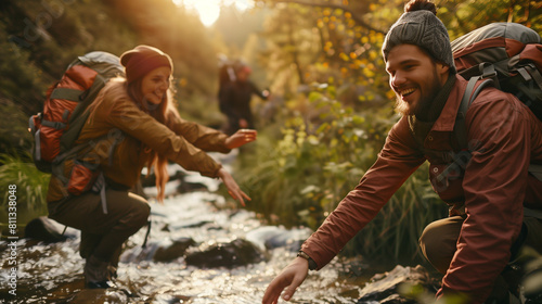 a group of tourists on a hike, going to the mountains with backpacks, forest, Expedition of pilgrims or camper, lifestyle travel, adventures, cross the river, help, friends, love nature, freedome photo