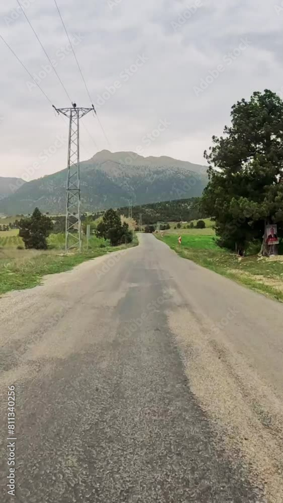 First-person view along highland road through mountain pass. Scenic drive captures highland road amidst natural surroundings. Video shows journey on highland road, revealing landscapes