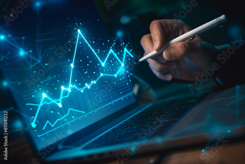 Businessman using a laptop and holding a pen to write on a virtual screen