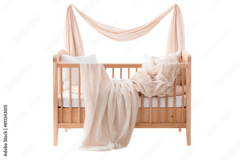 A wooden crib with a white canopy and a white blanket draped over it. The crib is empty and the blanket is covering the entire bed A wooden crib with a white canopy and a white blanket draped over it. The crib is empty and the blanket is covering the entire bed