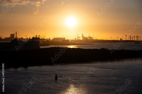 Rotterdam harbor cranes in the sunset
