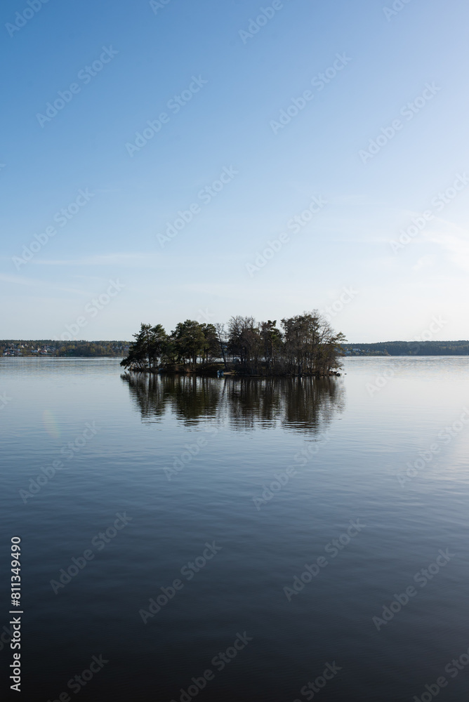 Concept of lonely island landscape: Kaninholmen - Swedish island,  lonely island surrounded by water, beautiful place on sunny evening