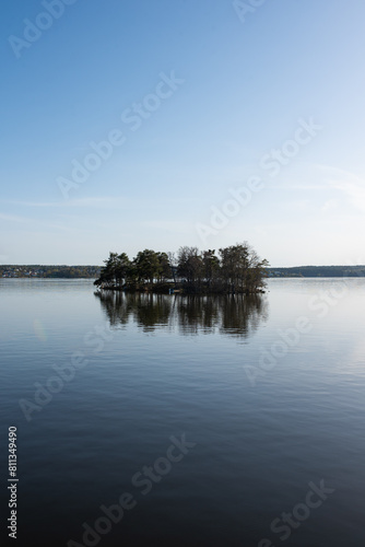 Concept of lonely island landscape: Kaninholmen - Swedish island,  lonely island surrounded by water, beautiful place on sunny evening © Andrii