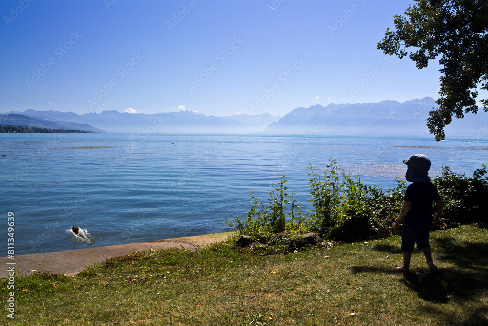 Boy in front of the Leman lake in Lausanne, Switzerland