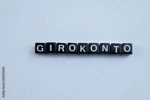 Concept of Girokonto written on wooden blocks. Cross processed image on Wooden Background photo