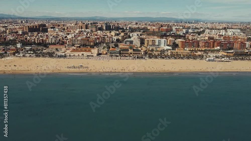 Aerial View of Bustling Coastal City and Expansive Beach on a Sunny Day