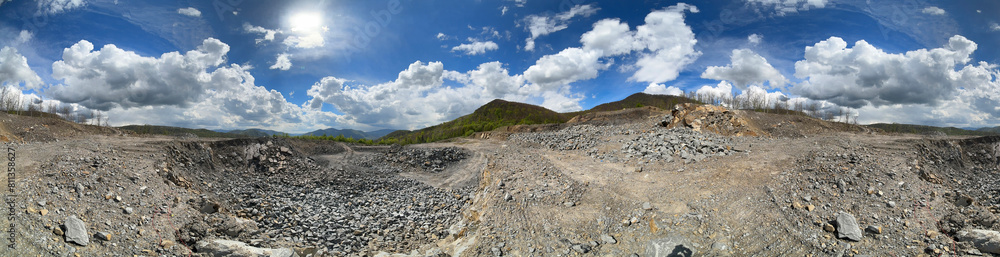 Carpathian Mountains of Ukraine, a quarry where granite sandstone is mined for the production of building materials, powerful trucks and conveyors load gravel - video from a drone Carpathian Mountains of Ukraine, a quarry where granite sandstone is mined for the production of building materials, powerful trucks and conveyors load gravel - video from a drone