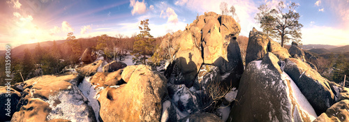 Dovbush rocks in winter in Bubnyshche, Carpathians, Ukraine, Europe. Huge stone giants rise in the snowy transparent beech forest, all-round panoramic views are unique without leaves photo