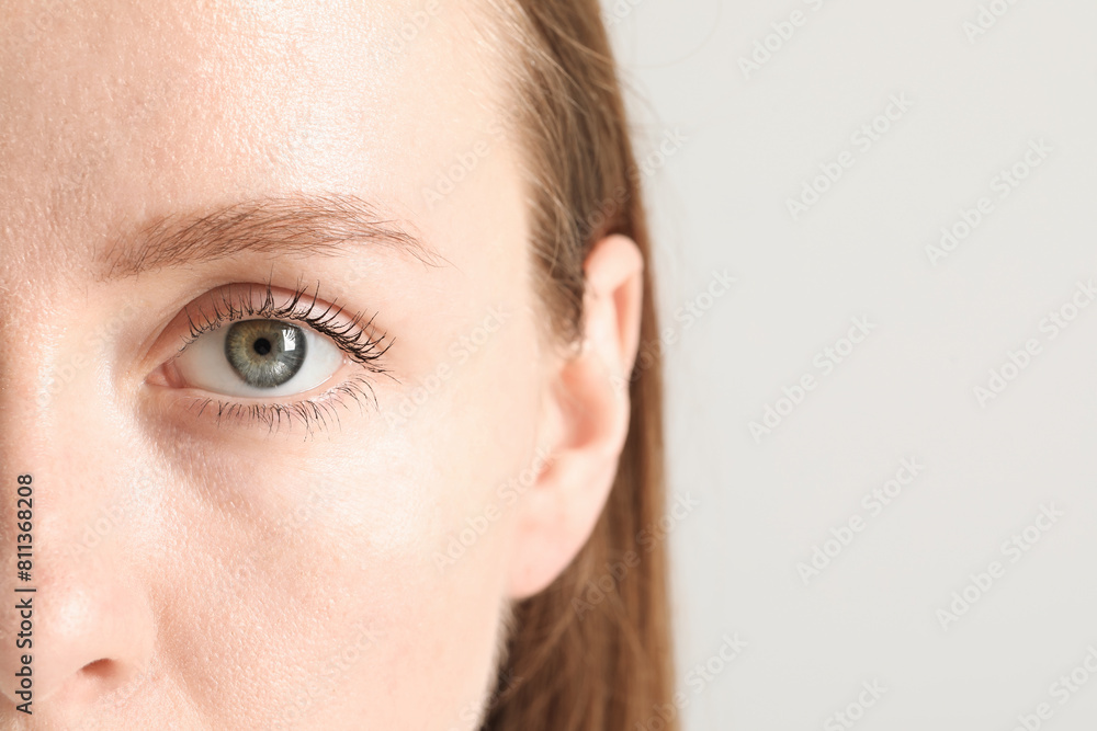 Closeup photo of woman with beautiful eyes on light background. Space for text Closeup photo of woman with beautiful eyes on light background. Space for text