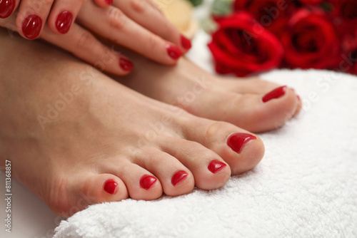 Woman with stylish red toenails after pedicure procedure on white floor  closeup