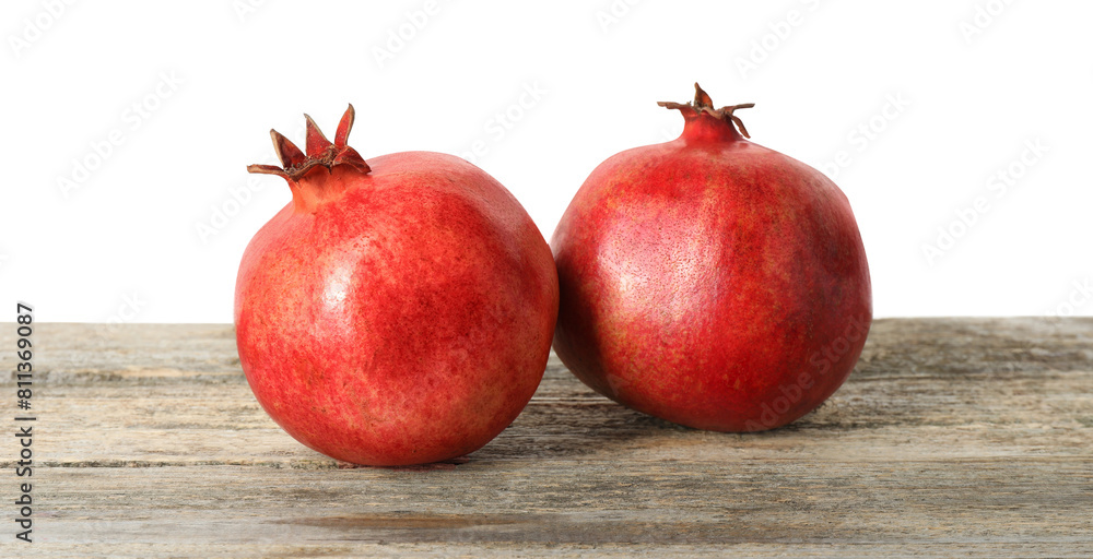 Fresh pomegranates on wooden table against white background Fresh pomegranates on wooden table against white background