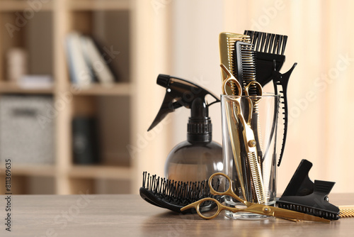 Set of hairdresser tools on table in salon, space for text