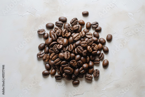 Collection of freshly roasted coffee beans tastefully arranged on a neutral, light-colored background, depicting the essence of coffee culture photo