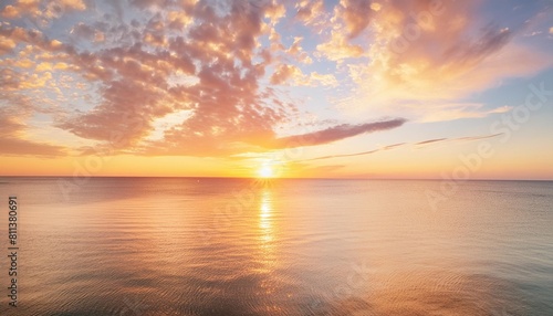 vivid sunset skies above tranquil ocean waters a mesmerizing view of the sun setting beneath a canvas of vibrant orange clouds reflecting on calm sea waters encapsulating the beauty of nature