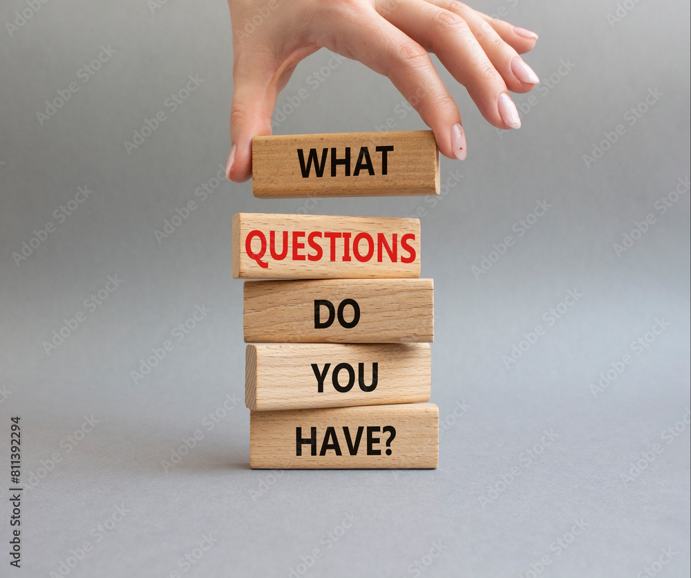 Questions symbol. Wooden blocks with words What Questions do you have. Beautiful grey background. Businessman hand. Business and What Questions do you have concept. Copy space. Questions symbol. Wooden blocks with words What Questions do you have. Beautiful grey background. Businessman hand. Business and What Questions do you have concept. Copy space.