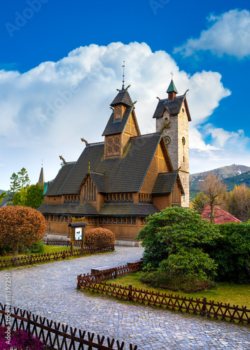 Medieval Norwegian wooden church Vang or Wang and Snezka mountain in the background. Karpacz, Poland